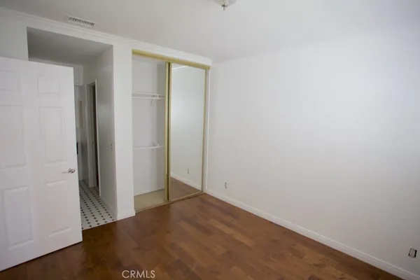 an empty room with wooden floor