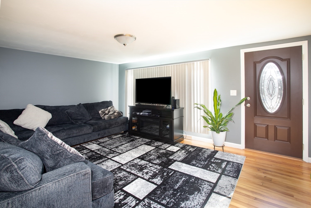 350 Gifford Road Westport, MA 02790 - Photo 11 of 39 a living room with furniture a flat screen tv and a wooden floor