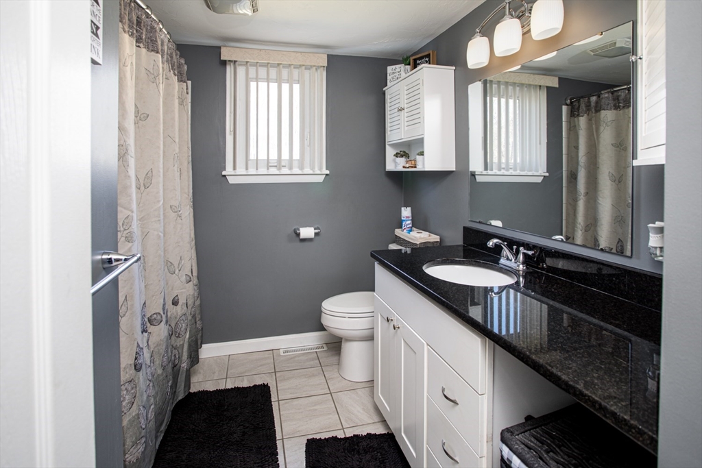 350 Gifford Road Westport, MA 02790 - Photo 19 of 39 a bathroom with a double vanity sink a toilet and a mirror