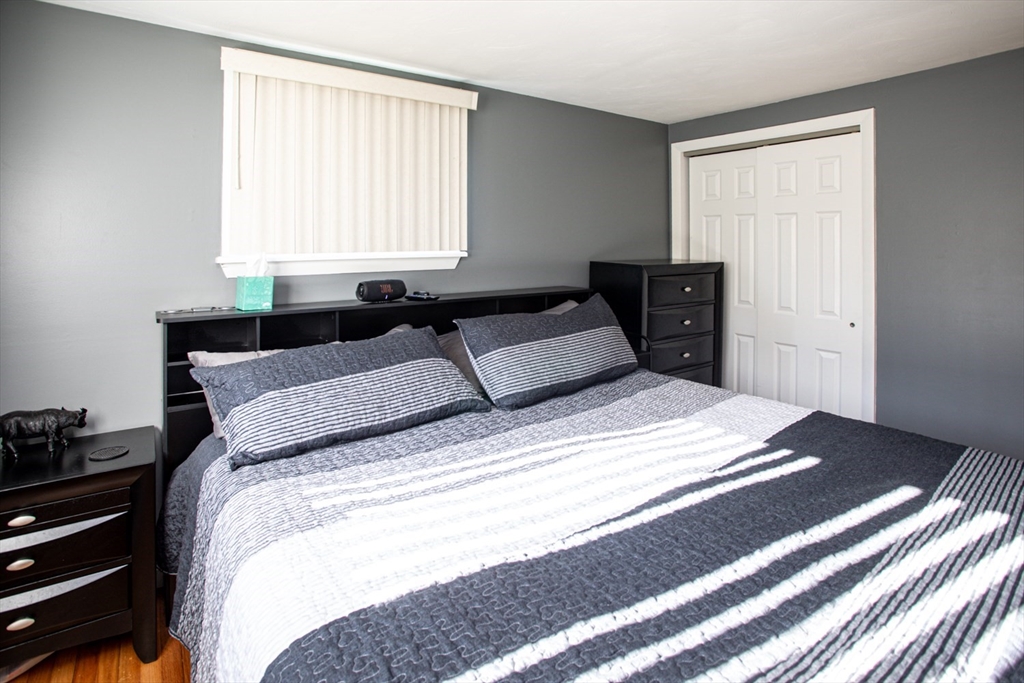 350 Gifford Road Westport, MA 02790 - Photo 21 of 39 a bedroom with a bed and wooden floor