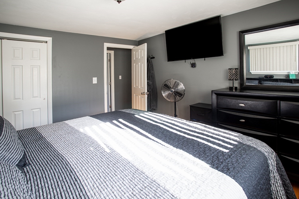 350 Gifford Road Westport, MA 02790 - Photo 22 of 39 a bedroom with a bed and a flat screen tv