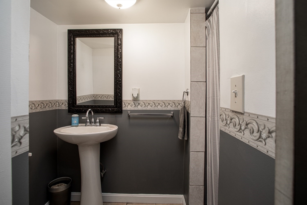 350 Gifford Road Westport, MA 02790 - Photo 29 of 39 a bathroom with a sink a mirror and shower