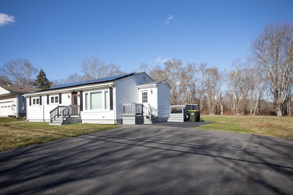350 Gifford Road Westport, MA 02790 - Photo 3 of 39 a front view of a house with a yard outdoor seating and covered with trees