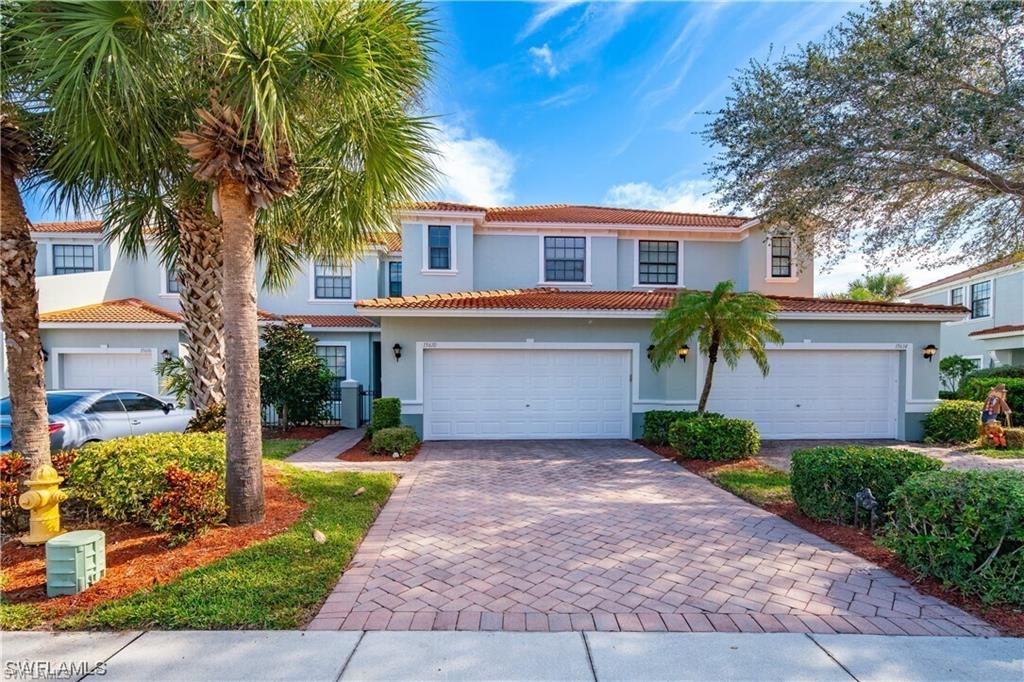 Mediterranean / spanish home featuring decorative driveway, stucco siding, a tile roof, and a garage