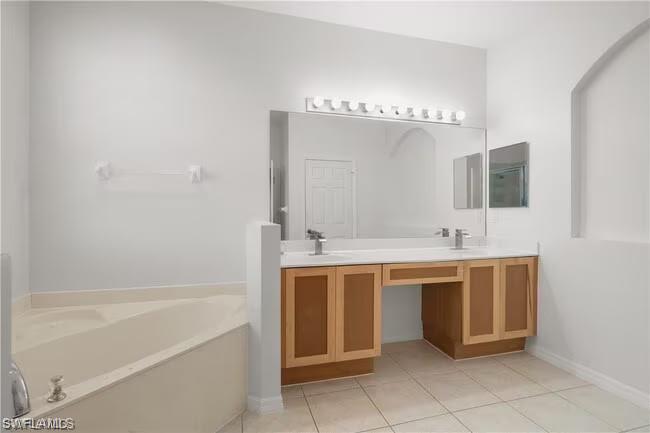 15610 Summit Pl Circle, Unit 398 Naples, FL 34119 - Photo 7 of 13 Full bathroom with a bath, double vanity, and light tile patterned floors