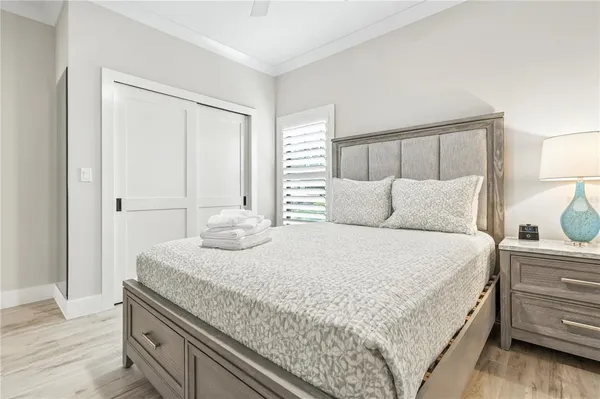 a bedroom with a bad and dresser