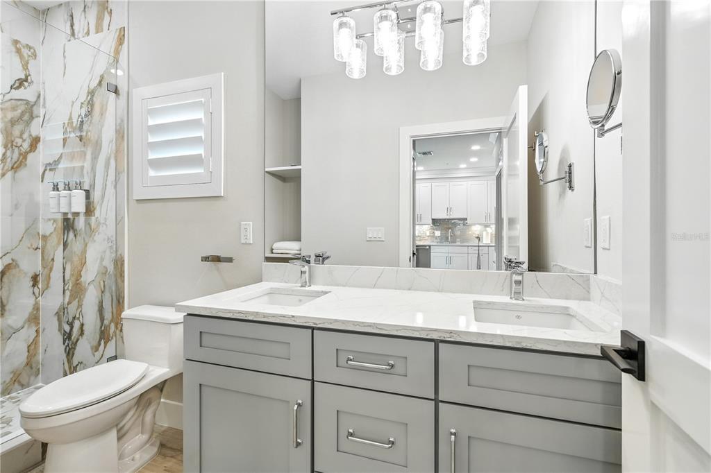 1234 15th Street, Unit 201 Sarasota, FL 34236 - Photo 20 of 29 a bathroom with a double vanity sink mirror and toilet