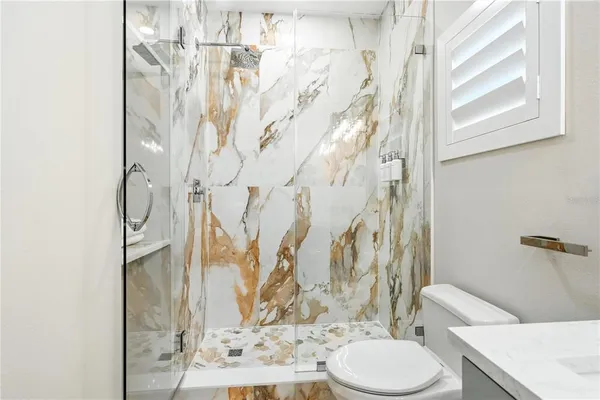 a white toilet sitting next to a bathroom sink