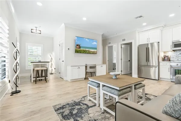 a open kitchen with stainless steel appliances kitchen island granite countertop a refrigerator and stove
