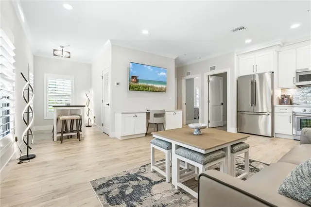 a open kitchen with stainless steel appliances kitchen island granite countertop a refrigerator and stove