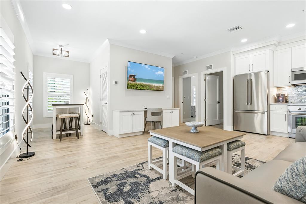1234 15th Street, Unit 201 Sarasota, FL 34236 - Photo 6 of 29 a open kitchen with stainless steel appliances kitchen island granite countertop a refrigerator and stove
