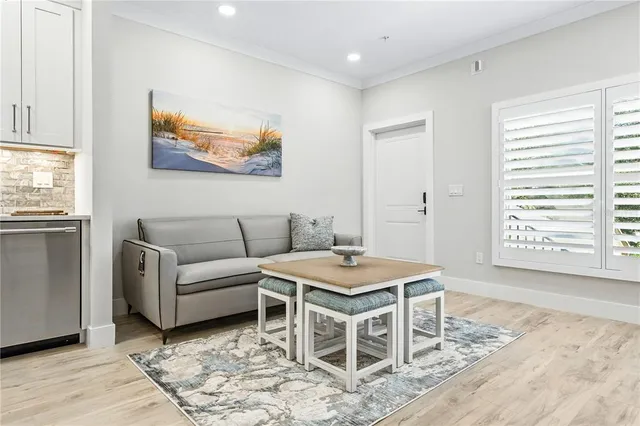 a living room with furniture a rug and a window