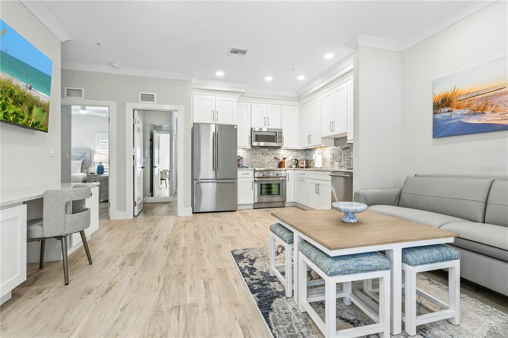 1234 15th Street, Unit 201 Sarasota, FL 34236 - Photo 10 of 29 a kitchen with a table chairs refrigerator and microwave