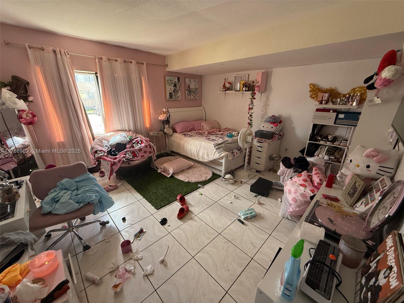417 Northwest 84th Street, Unit 417 Miami, FL 33150 - Photo 11 of 26 a bedroom with furniture and a window