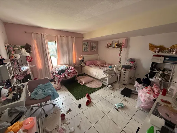 a bedroom with furniture and a window