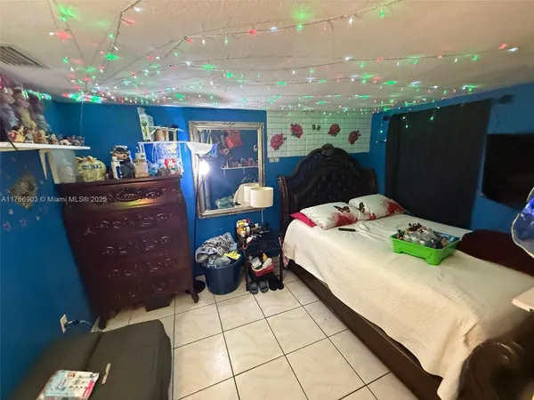 a bed room with a bed mirror and furniture