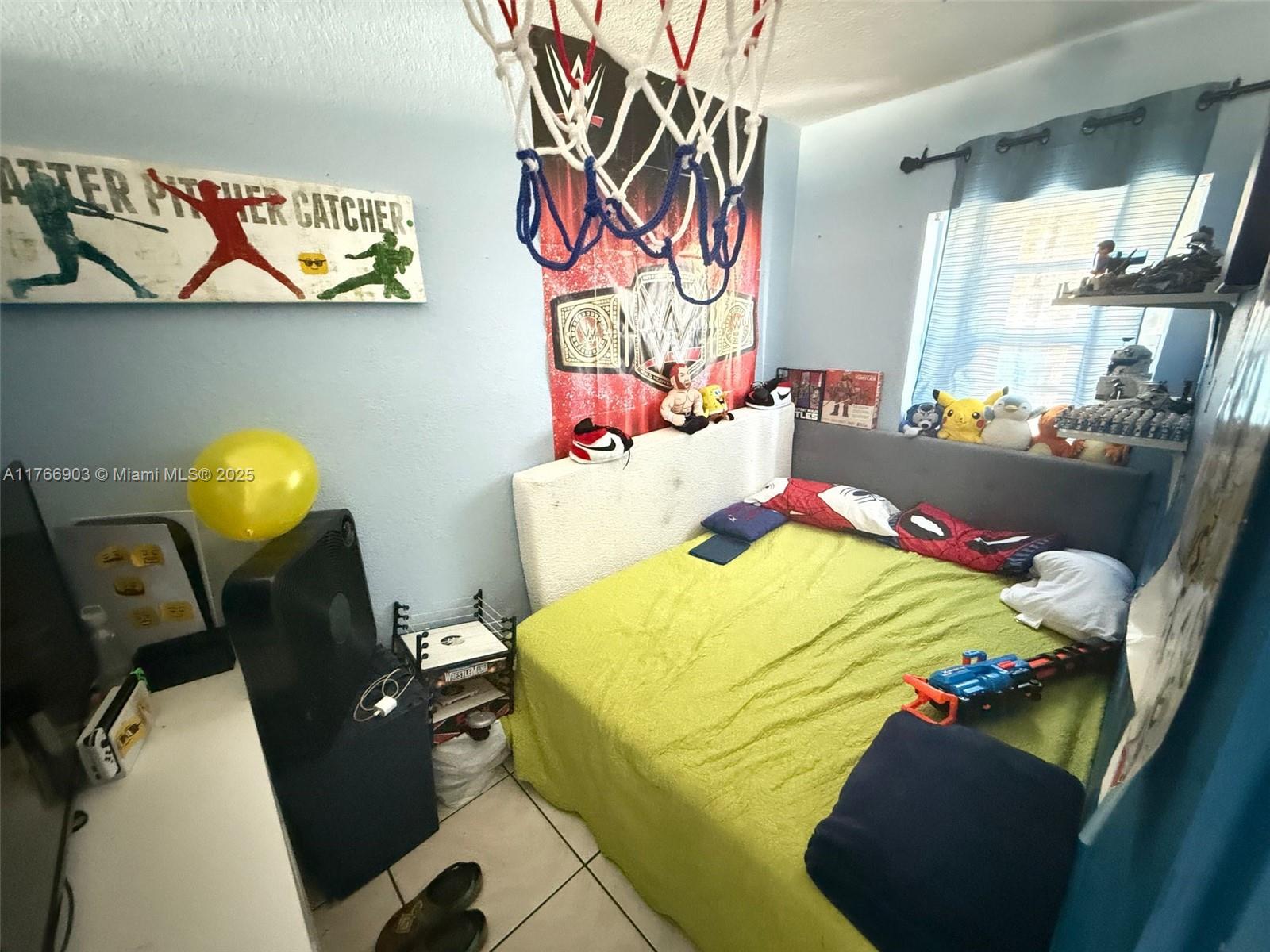 417 Northwest 84th Street, Unit 417 Miami, FL 33150 - Photo 18 of 26 a bed room with a bed and a chair