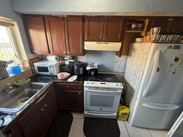 a kitchen with a stove and a refrigerator