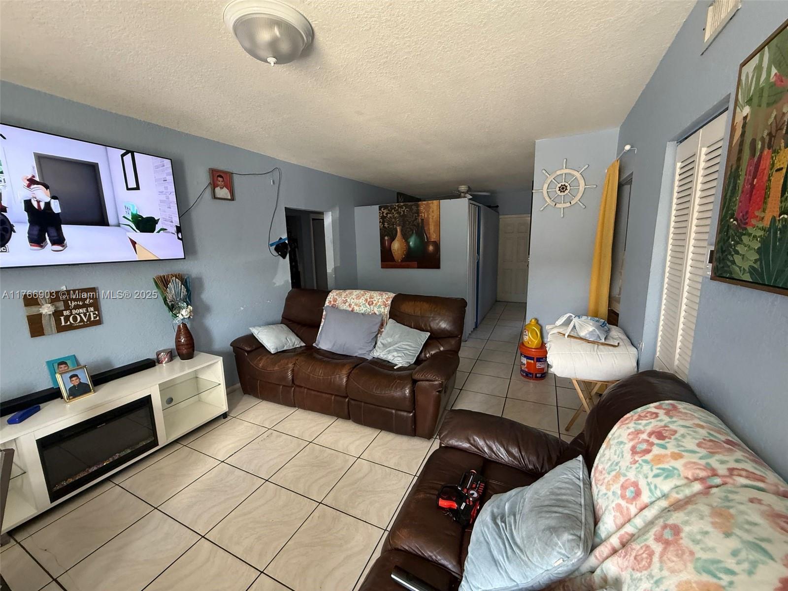 417 Northwest 84th Street, Unit 417 Miami, FL 33150 - Photo 25 of 26 a living room with furniture and a couch