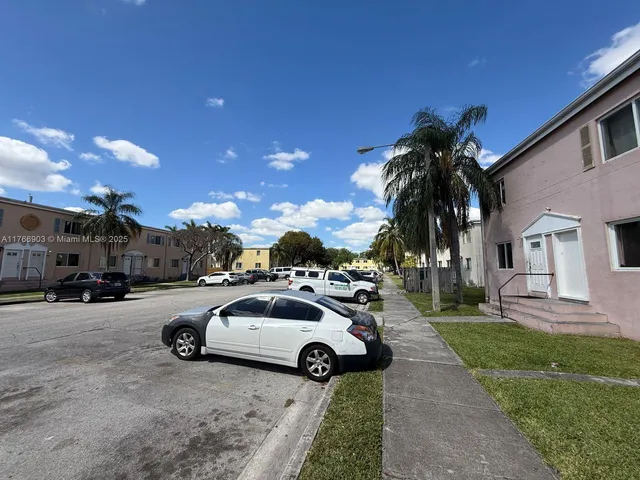 a view of a street with a car parked in front of it