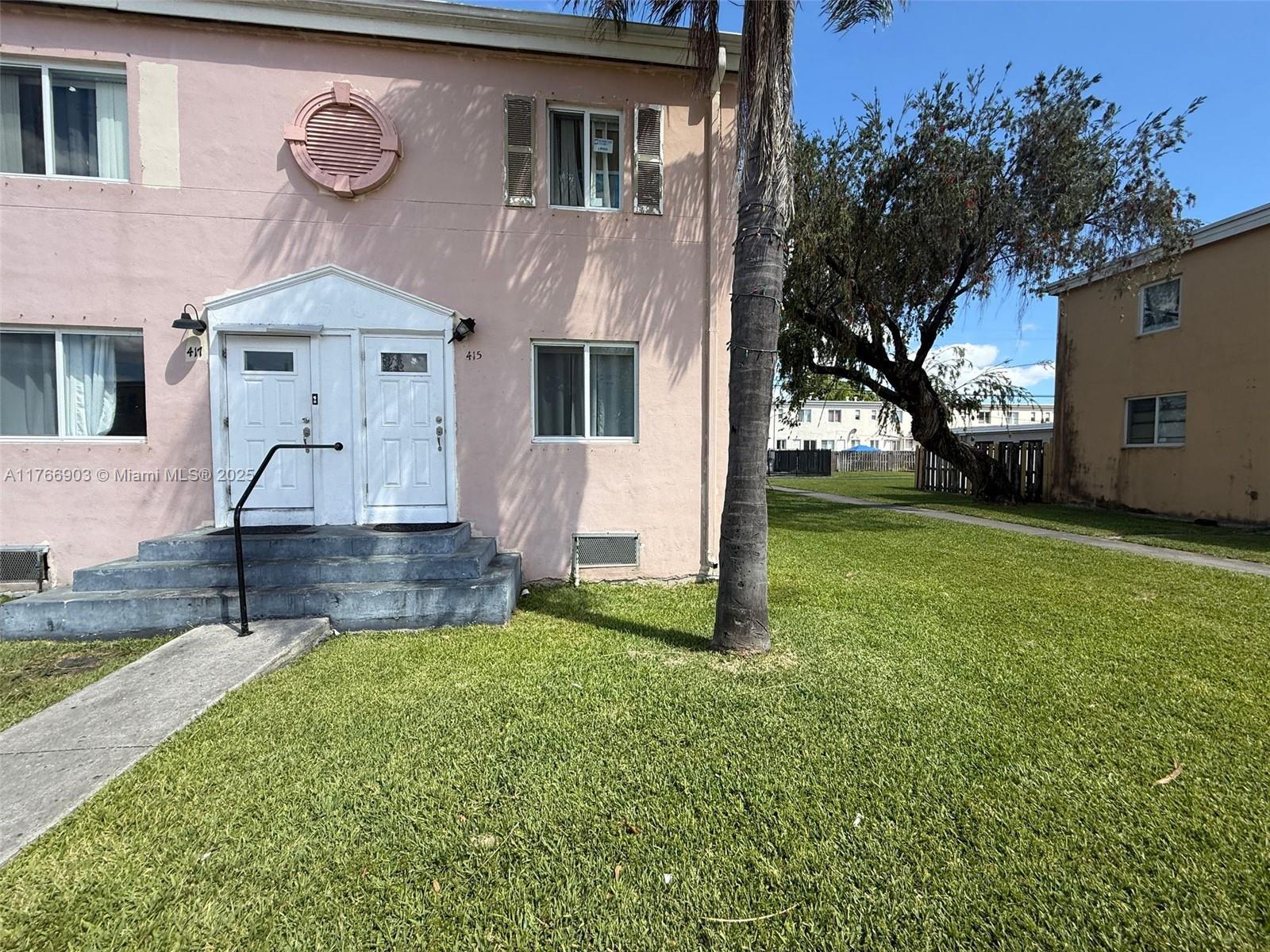 417 Northwest 84th Street, Unit 417 Miami, FL 33150 - Photo 8 of 26 a front view of house with yard