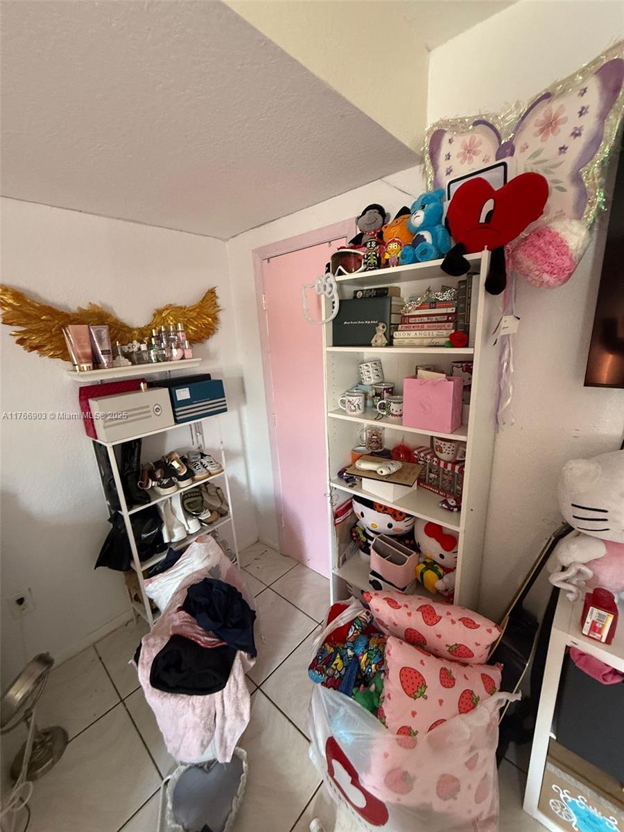 417 Northwest 84th Street, Unit 417 Miami, FL 33150 - Photo 9 of 26 a room with lots of different colored cloths