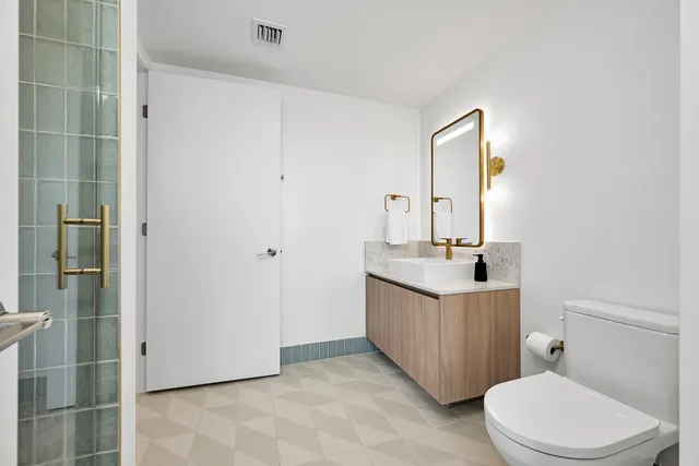 a bedroom with a large bed and a flat screen tv