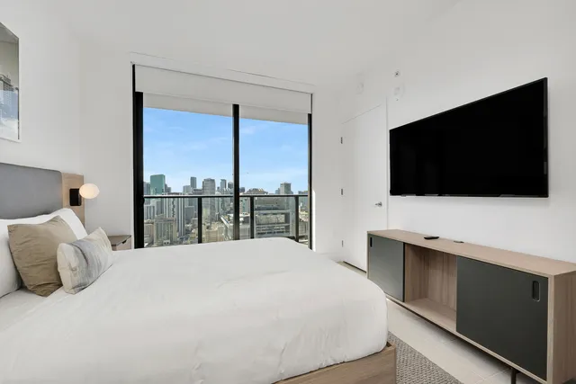 a bedroom with a bed and a view of bathroom