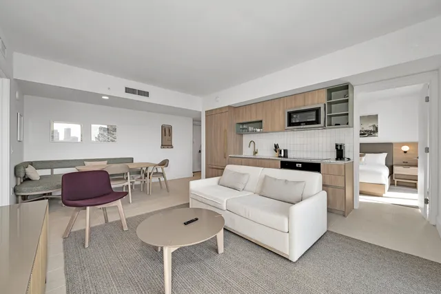 a kitchen with stainless steel appliances white cabinets and a refrigerator
