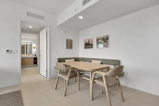a living room with furniture a flat screen tv and a floor to ceiling window
