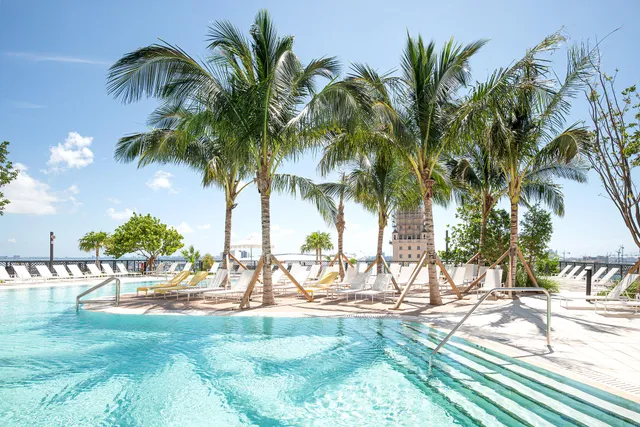 a view of a patio with a table and chairs under an umbrella
