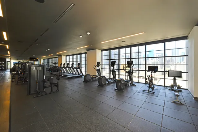 a living room with furniture and floor to ceiling windows