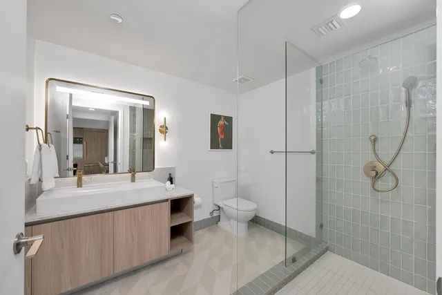 a bedroom with a bed a ceiling fan and a large window