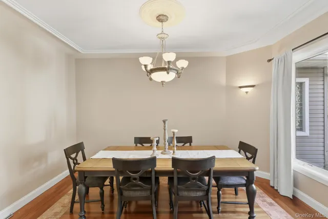 a view of a dining room with a table and chairs