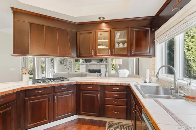 a kitchen with a sink stove top oven and cabinets