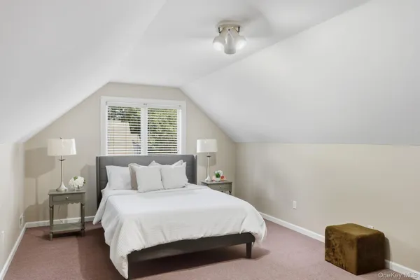 a bedroom with a bed and a chair