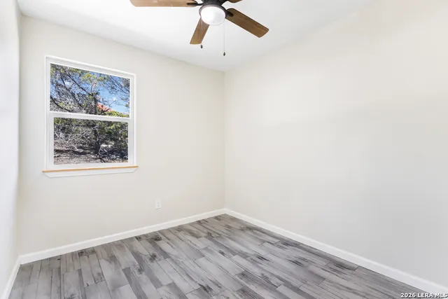 an empty room with a painting on the wall