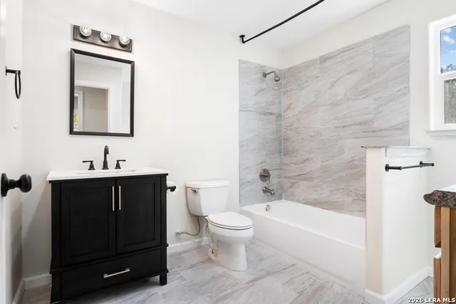 a bathroom with a sink a toilet and bathtub