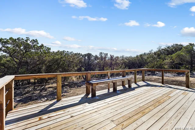 a view of balcony with wooden floor and fence