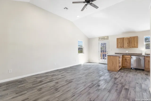 a view of a kitchen with wooden floor and electronic appliances