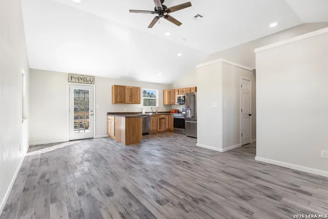 a view of a kitchen with a sink cabinet wooden floor and a window