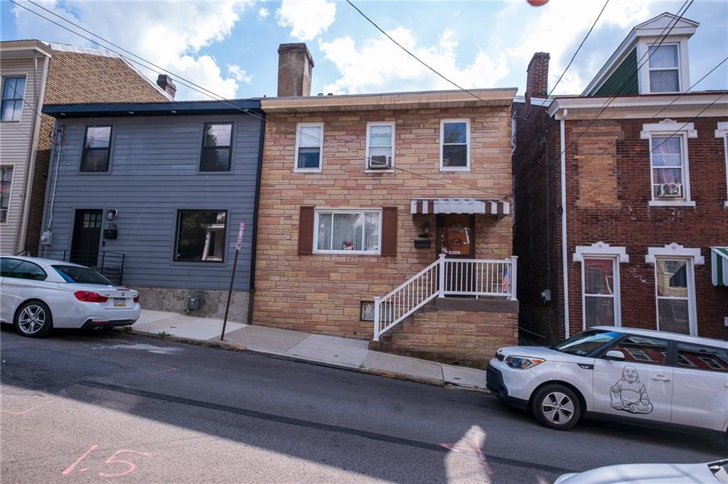 a car parked in front of a brick house