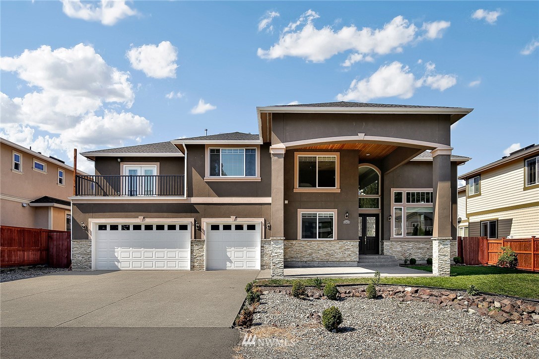 12421 155th Avenue Southeast Renton, WA 98059 - Photo 1 of 1 a front view of a residential apartment building with a yard