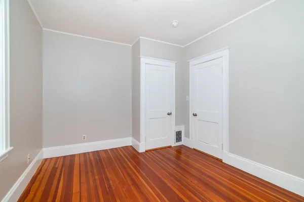 a view of room with wooden floor