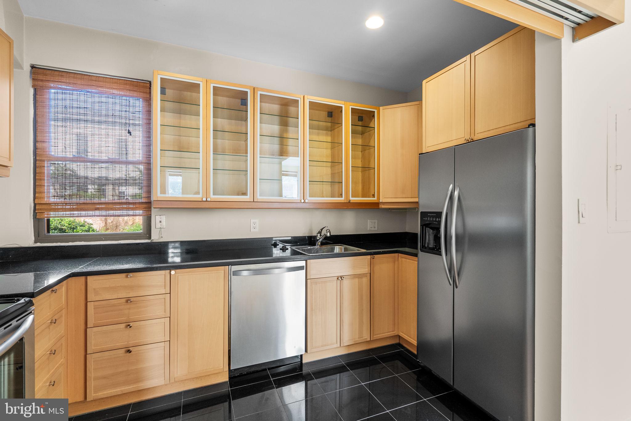 1318 35th Street Northwest, Unit 7 Washington, DC 20007 - Photo 14 of 27 a kitchen with granite countertop a refrigerator and a sink