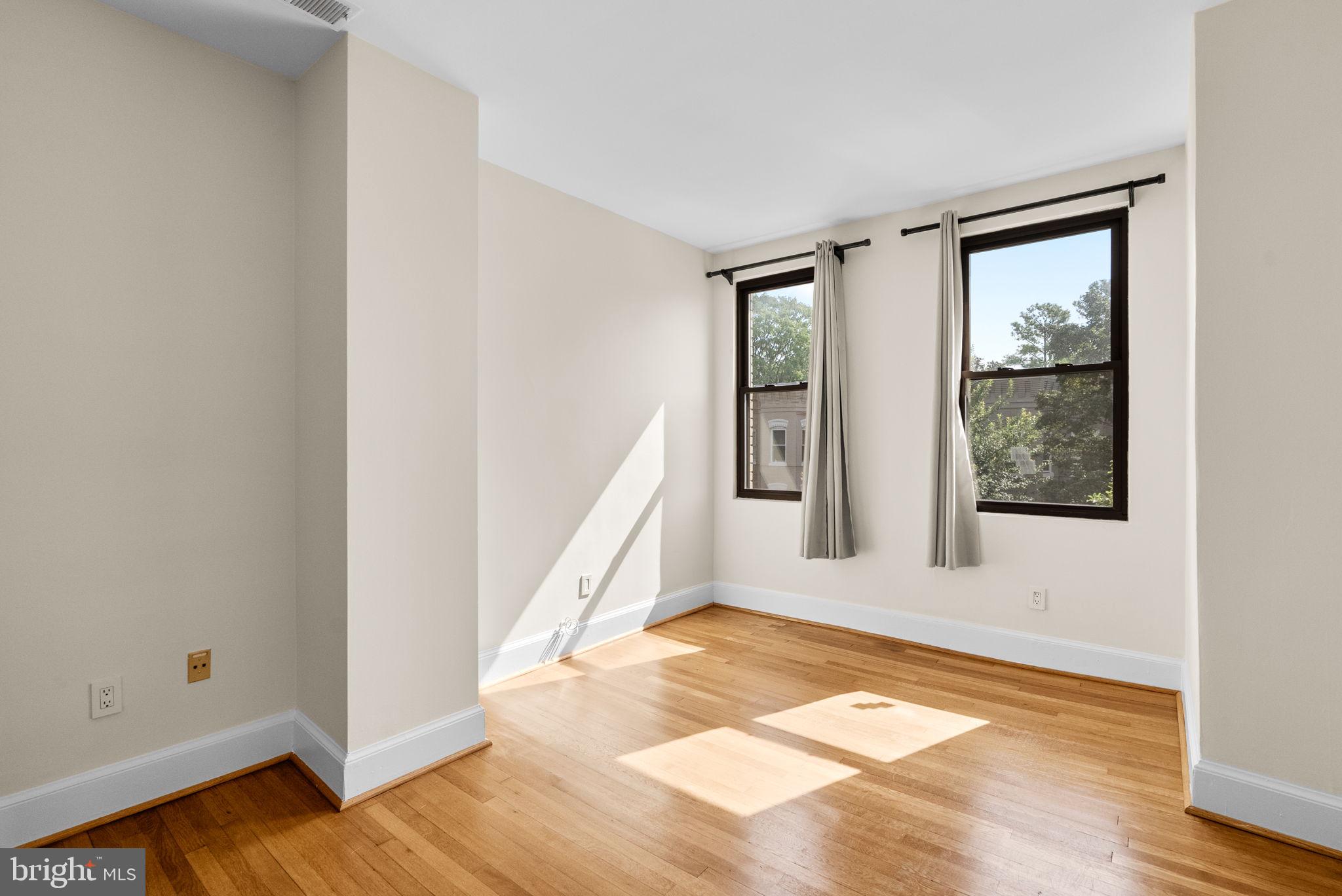 1318 35th Street Northwest, Unit 7 Washington, DC 20007 - Photo 16 of 27 a view of a room with wooden floor and windows