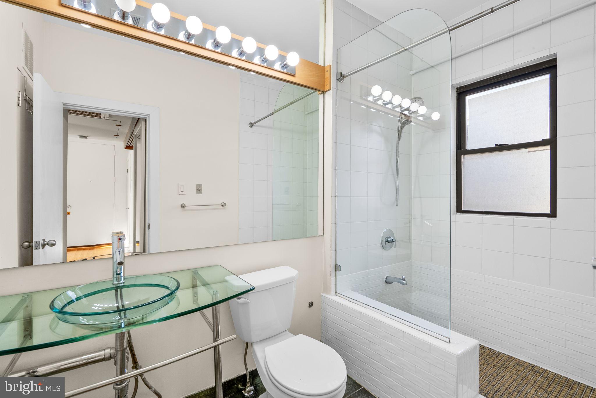 1318 35th Street Northwest, Unit 7 Washington, DC 20007 - Photo 18 of 27 a bathroom with a sink a toilet and shower