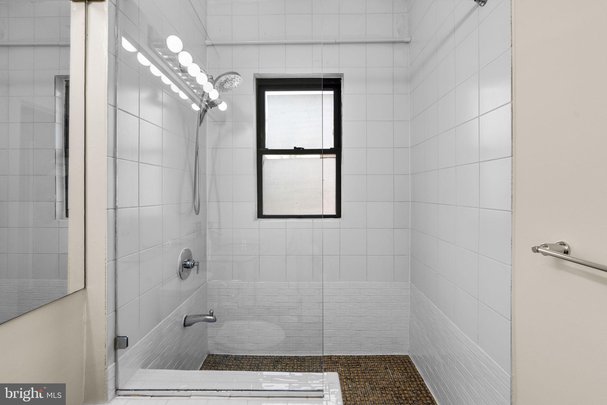 1318 35th Street Northwest, Unit 7 Washington, DC 20007 - Photo 19 of 27 a bathroom with a glass shower door