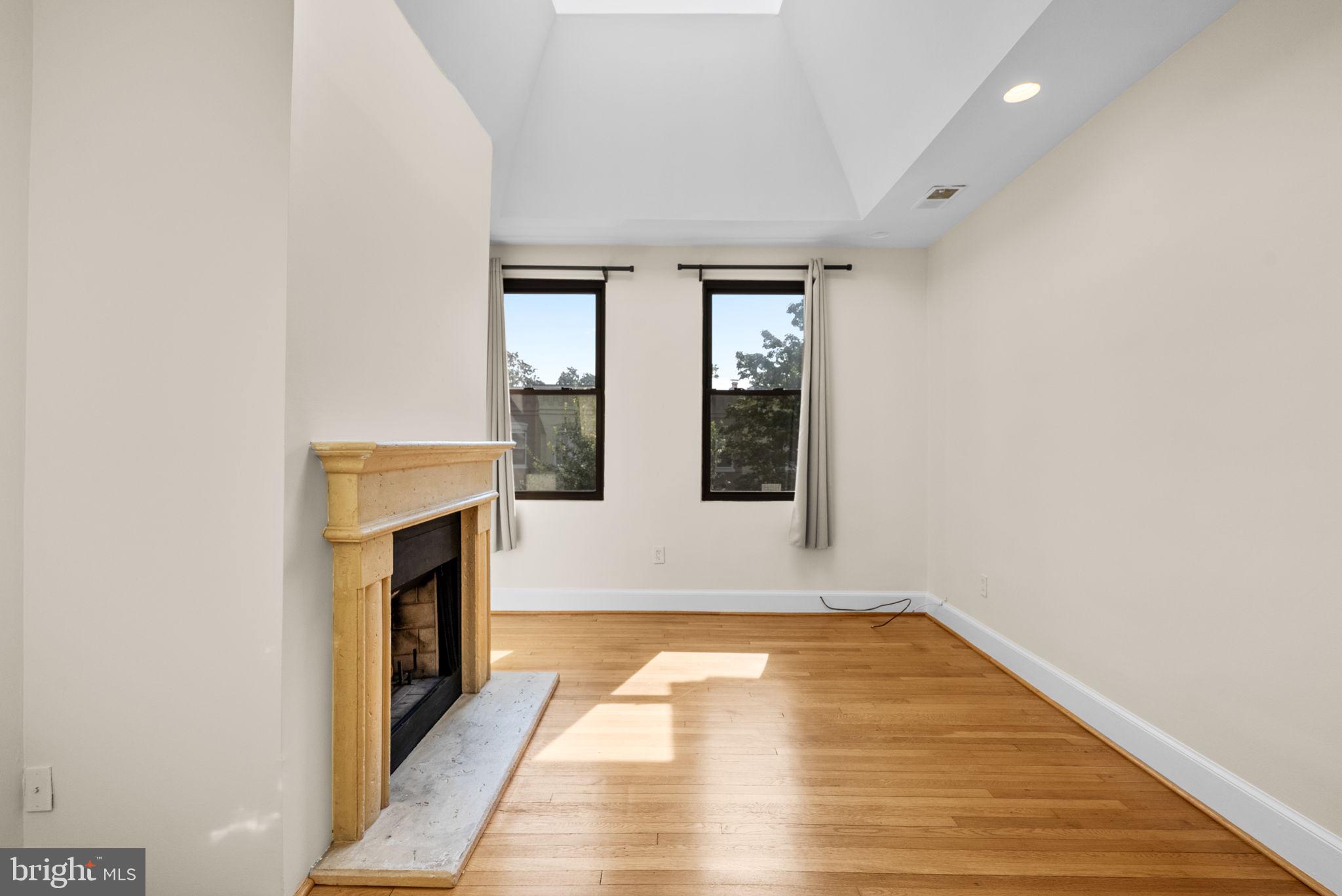 1318 35th Street Northwest, Unit 7 Washington, DC 20007 - Photo 7 of 27 a view of empty room with wooden floor and fireplace