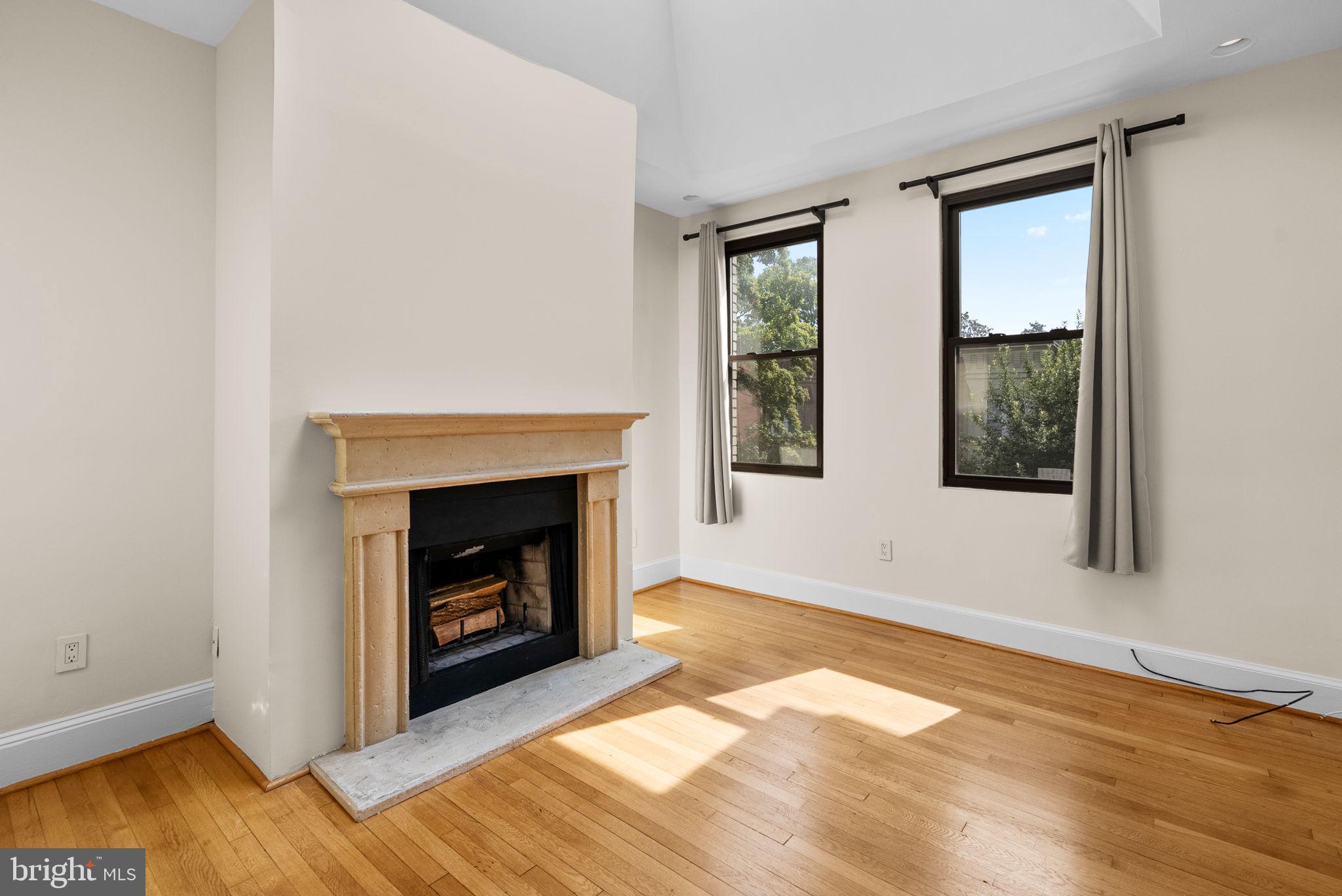 1318 35th Street Northwest, Unit 7 Washington, DC 20007 - Photo 8 of 27 a view of an empty room with window and fire place